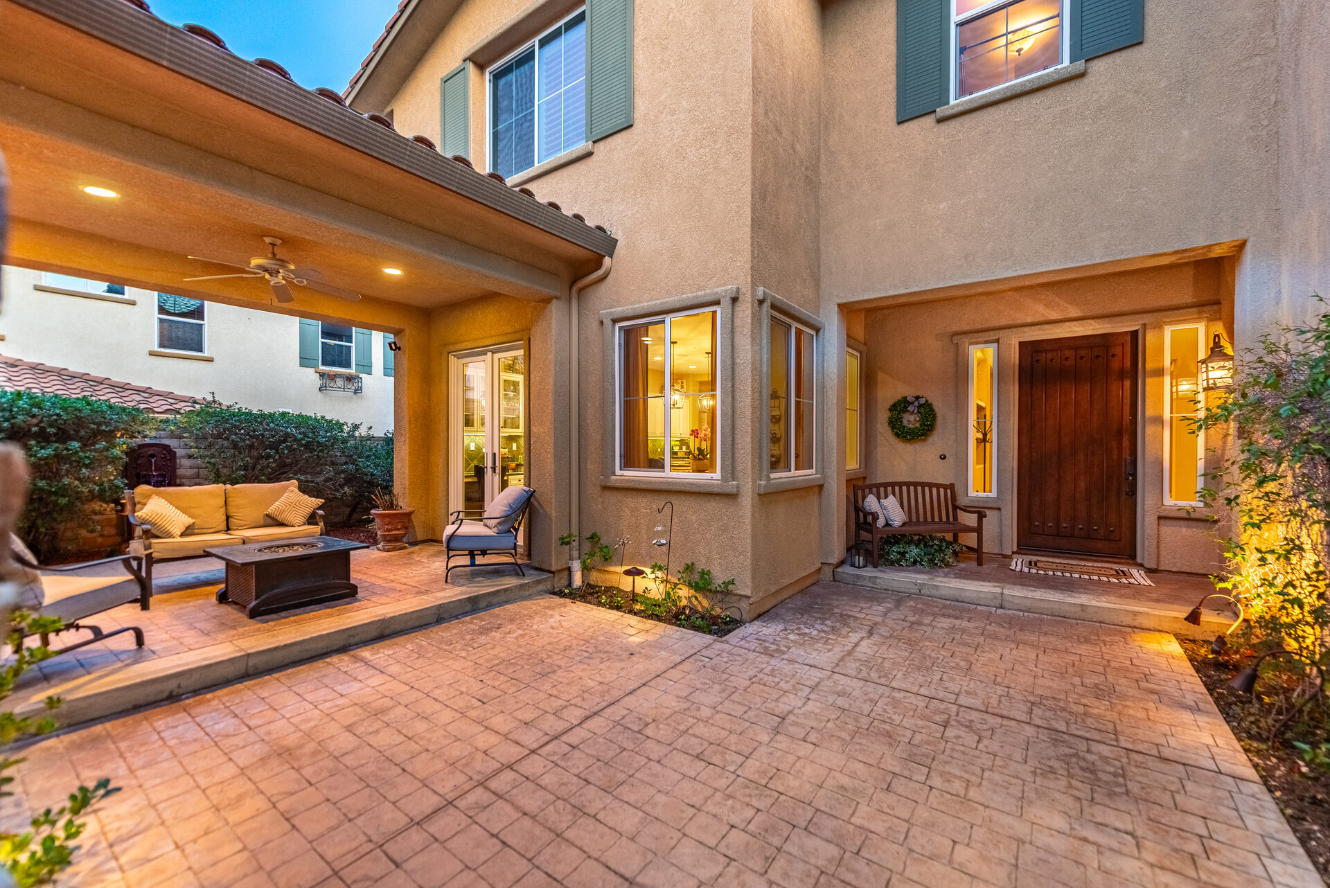 Twilight view of the entry courtyard with warm lighting